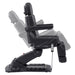 Aurora Quad-Motor Swivel Procedure Chair Black Side View Demonstrating Chair And Stirrup Adjustment Positions On White Background