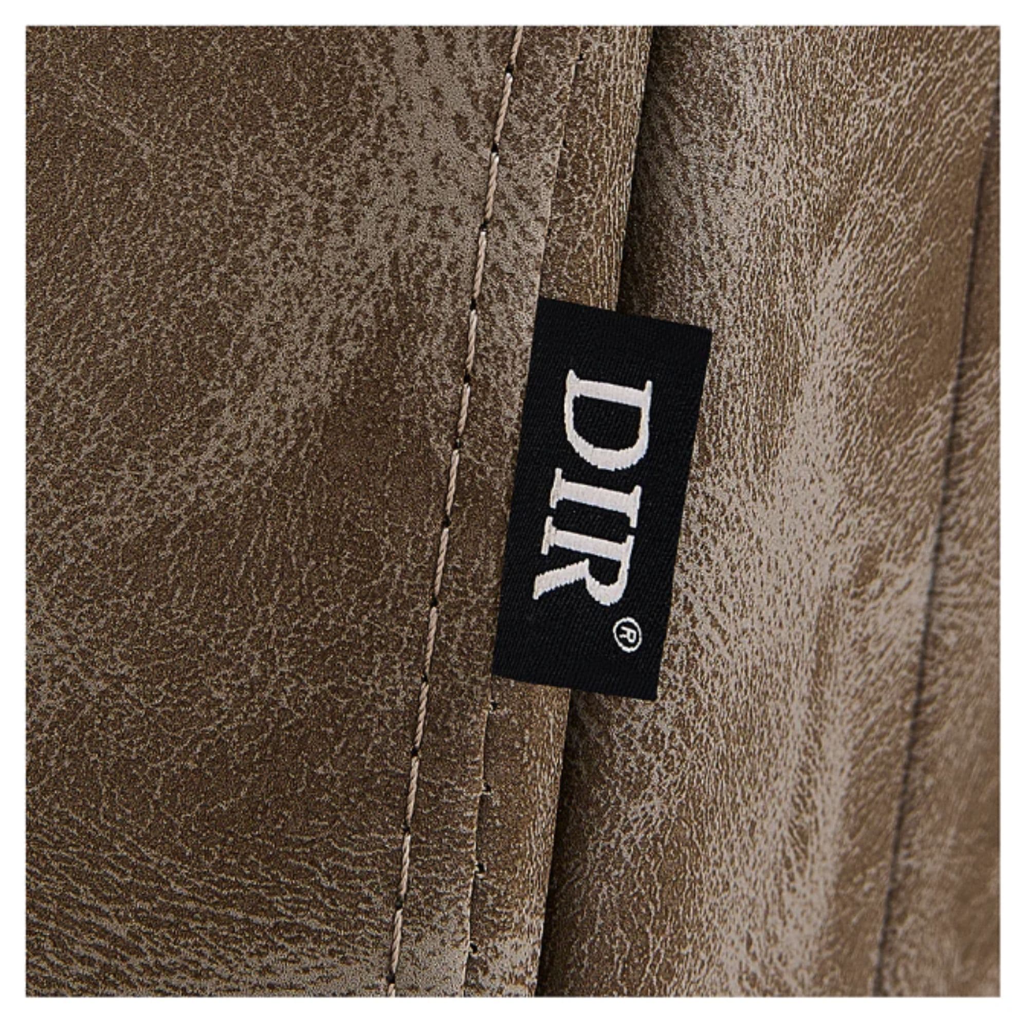 Belgrano Classic Barber Chair Close-Up View Of Vintage Brown Upholstery With Horizontal Stitching And Brand Name