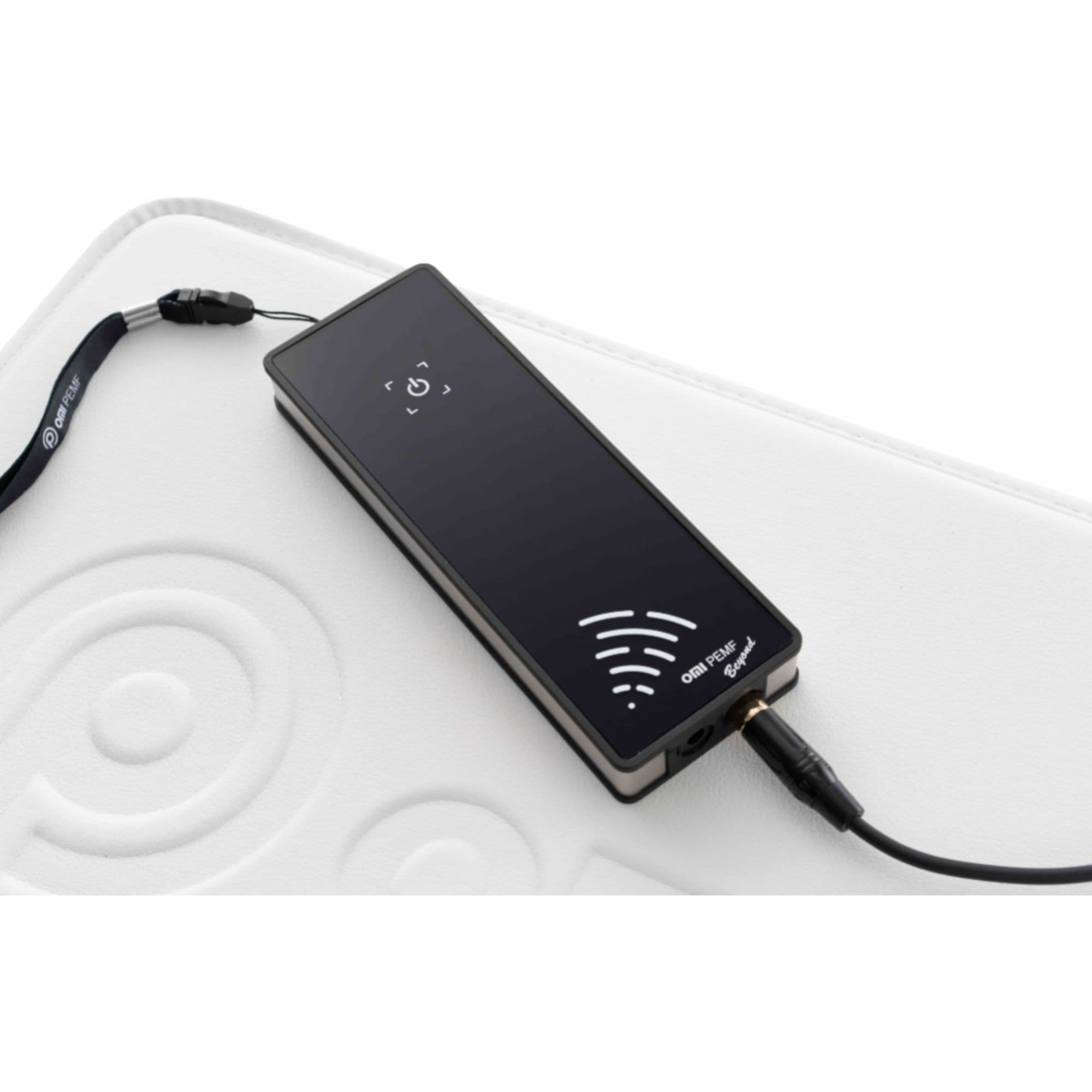 Beyond Power PEMF System by OMI With Modern Wellness Device On White Therapy Mat