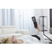 Ceragem V4 With A Woman Relaxing While Holding The Wired Remote Control