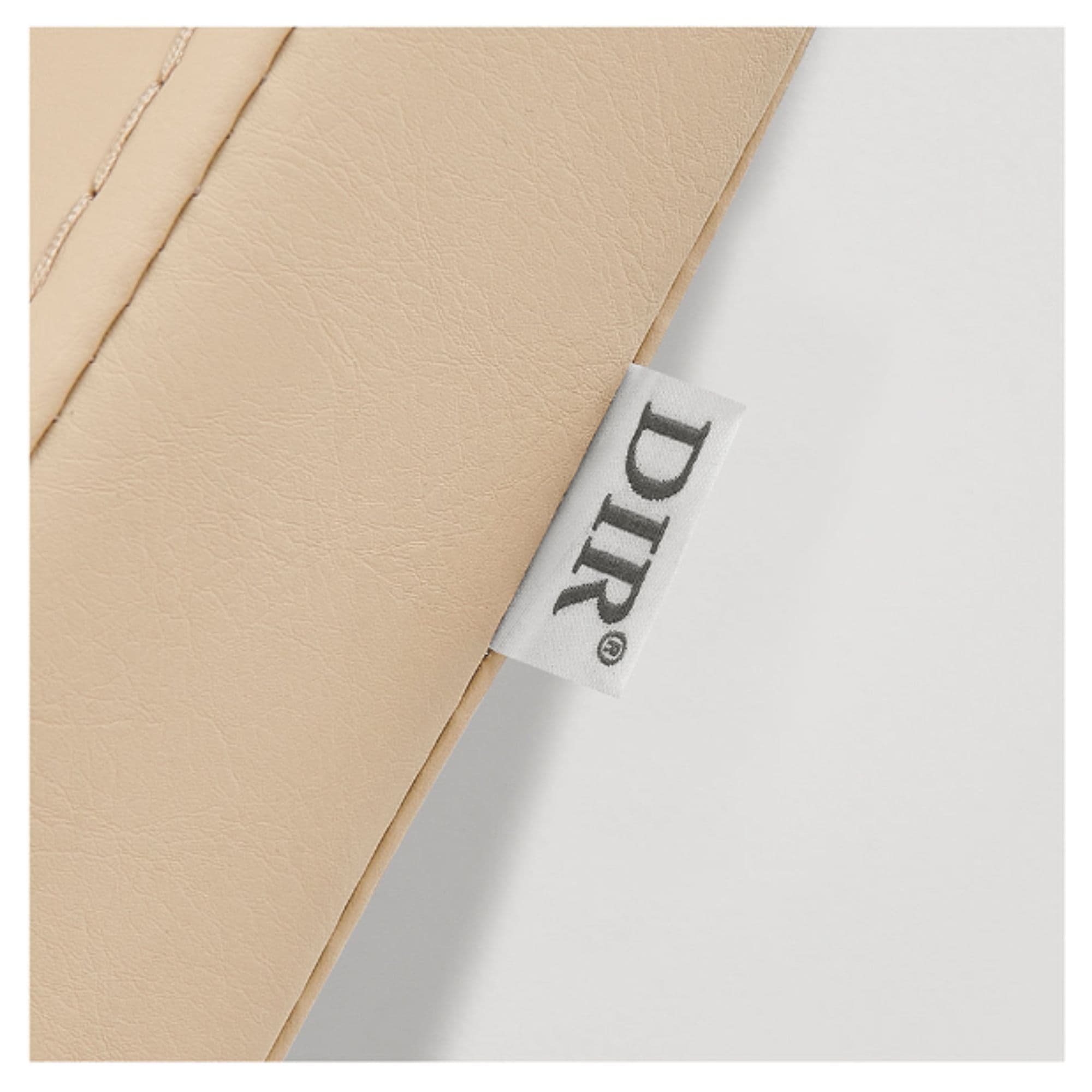 DIR Beckman Gold Shampoo Chair with Adjustable Seat Close-Up View Of Beige Upholstery With Brand Name