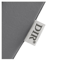 Thumbnail for DIR Beckman Salon Shampoo Unit with Adjustable Seat Close-Up View Of Gray Upholstery With Brand Name