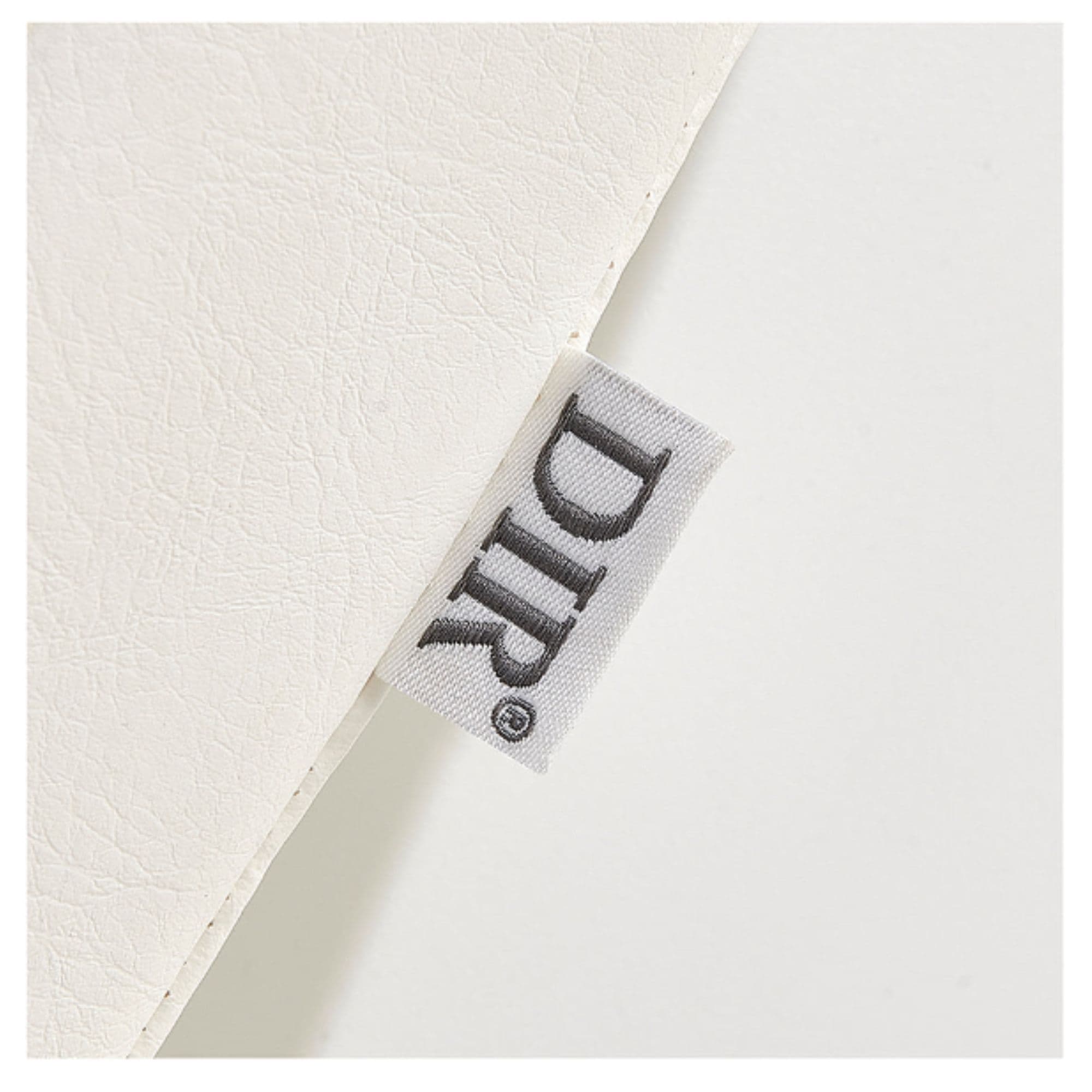 DIR Beckman Salon Shampoo Unit with Adjustable Seat Close-Up View Of White Upholstery With Brand Name