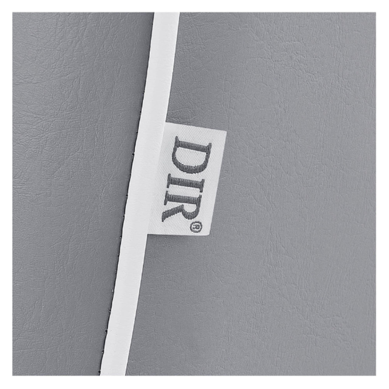 DIR Dainty Reclining Salon Chair Close-Up View Of Gray Upholstery With Brand Name