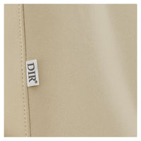 Thumbnail for DIR Geneva 4-Motors OB GYN Exam Table with Stirrups Close-Up View Of Beige Upholstery With Brand Name