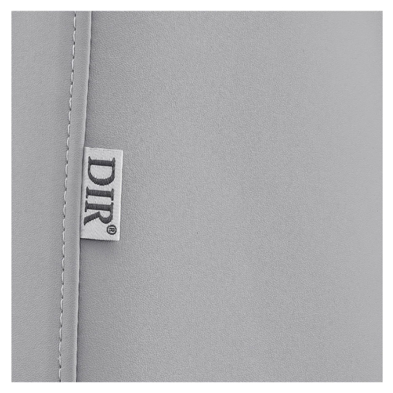 DIR Geneva 4-Motors OB GYN Exam Table with Stirrups Close-Up View Of Gray Upholstery With Brand Name
