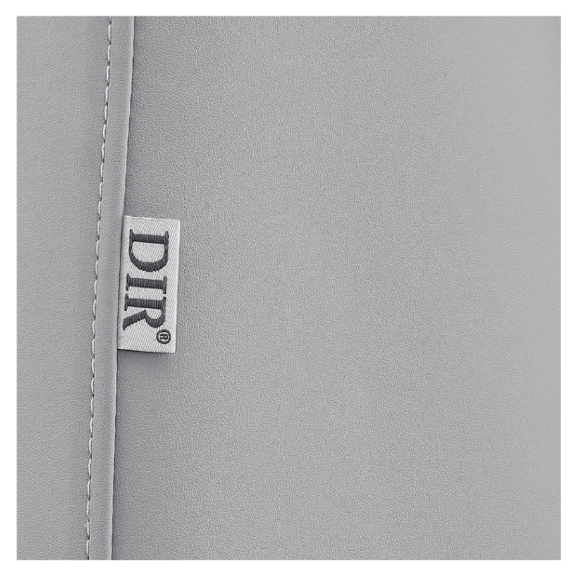 DIR Geneva 4-Motors OB GYN Exam Table with Stirrups Close-Up View Of Gray Upholstery With Brand Name