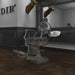 DIR Kaiser Retro Style Vintage Barber Chair Black Variant Front Angled View With Mirror A Brand Name And A Deer Head Sculpture In The Background