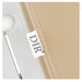 DIR Luxi 4-Motor Electric Spa Treatment Table Close-Up View Of Beige Upholstery With Brand Name And Stitching On White Background
