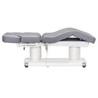 Thumbnail for DIR Luxi 4-Motors Medical Spa Treatment Bed Side View And Fully Reclined Of Gray Color With Semi-Folded Leg Section And Remote Control On White Background