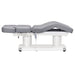 DIR Luxi 4-Motors Medical Spa Treatment Bed Side View And Fully Reclined Of Gray Color With Semi-Folded Leg Section And Remote Control On White Background