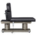 DIR Luxi 4-Motors Medical Spa Treatment Bed Side View Of Black Color And Fully Reclined On Head Section With Remote Control On White Background