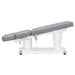 DIR Luxi 4-Motors Medical Spa Treatment Bed Side View Of Gray Color Fully Reclined Chair With Raised Leg Section And Remote Control On White Background