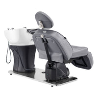Thumbnail for DIR Maximus Spa Salon Reclining Shampoo Bed with Rotating Seat Gray Angled Rear View Beside White Sink On White Background