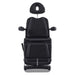 DIR Pavo 4-Motors Swivel Medical Spa Treatment Table Black Variant Front View With Raised Headrest On White Background