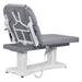 DIR Tranquility 4-Motor Medical Spa Bed Rear View Of Gray Variant And Fully Reclined On Head Section With Remote Control On White Background