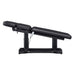 DIR Tranquility 4-Motors Electric Medical Spa Treatment Table Side View Of Black Variant Fully Reclined Chair And Raised Head Section With Remote Control On White Background