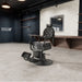 DIR Viking Traditional Barbershop Chair Black Variant Front Angled View With Mirror And Brand Name In The Background