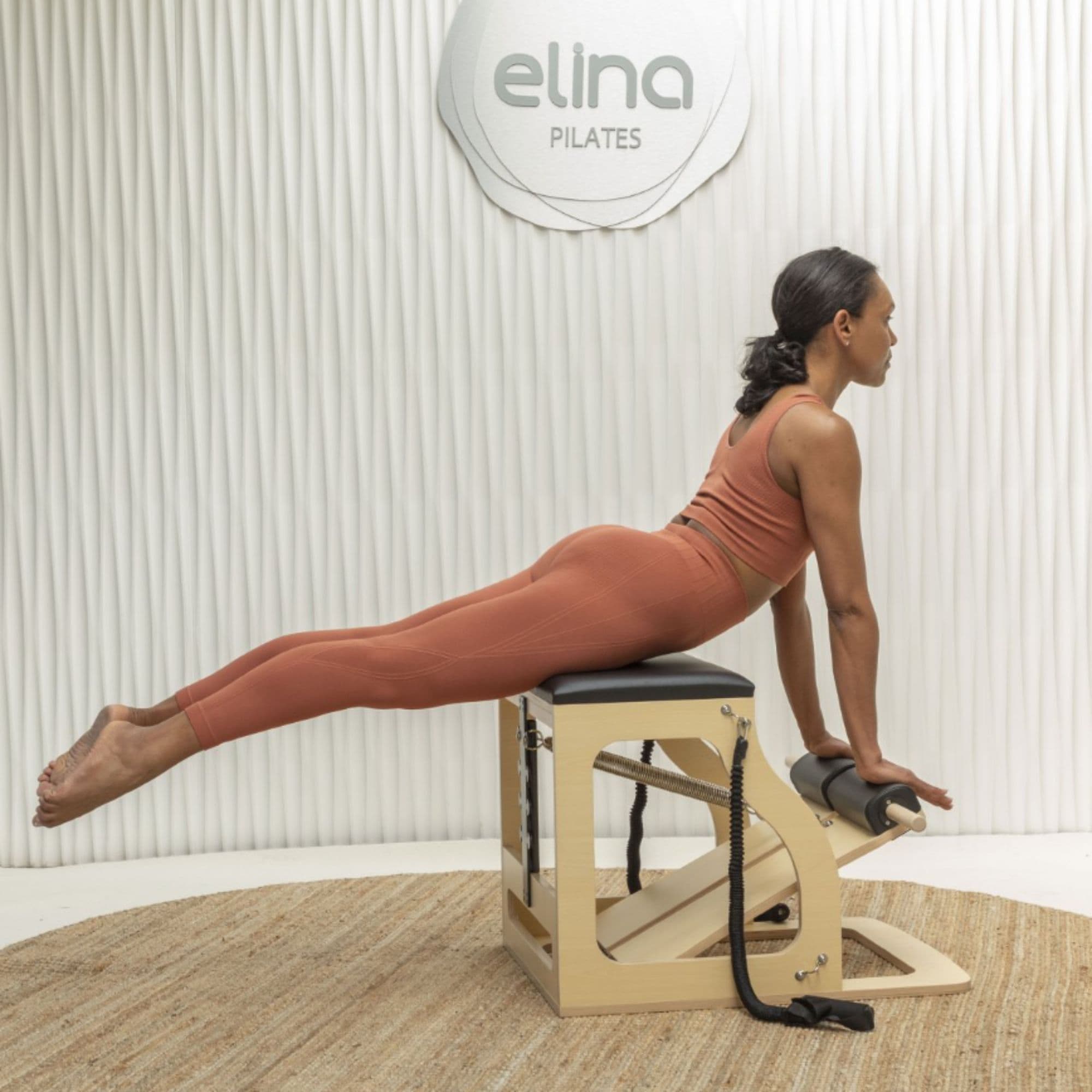Elina Alma Chair With A Woman Performing A Cobra Pose Exercise And Brand Logo In The Background