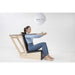 Elina Baby Chair With A Woman Performing A Seated Upper Body Pilates Exercise
