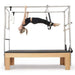 Elina Cadillac Side View Of A Woman Demonstrating A Pilates Exercise Using Leg Straps