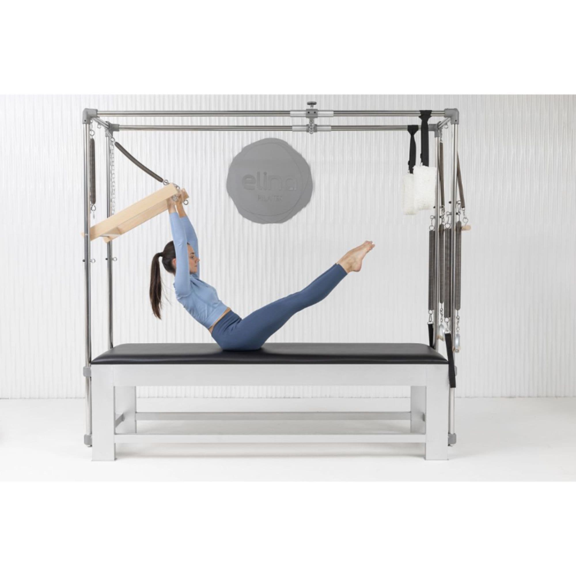 Elina Classic Aluminium Cadillac Trapeze Side View With A Women Performing A Pilates Exercise And Brand Name In The Background