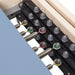 Elina Master Instructor Reformer with Tower Close-Up View Of Color Coded Spring Resistance Controls On White Background