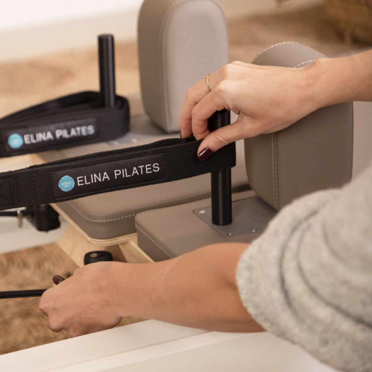Elina Nubium Pilates Reformer Close-Up View Of Adjustable Shoulder Rests And Carriage Strap System