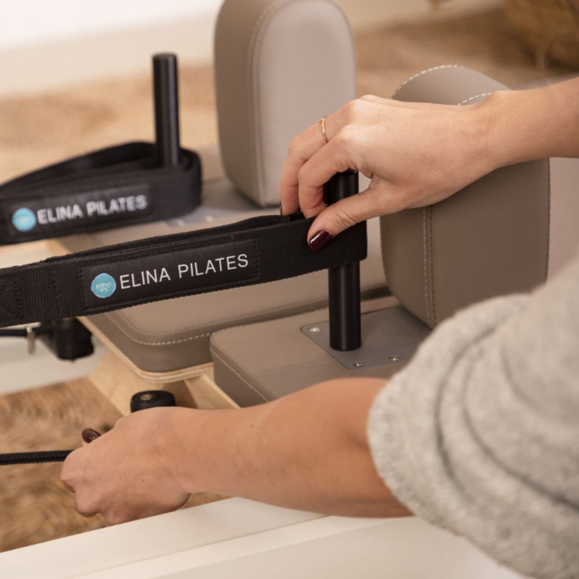 Elina Nubium Pilates Reformer Close-Up View Of Adjustable Shoulder Rests And Carriage Strap System