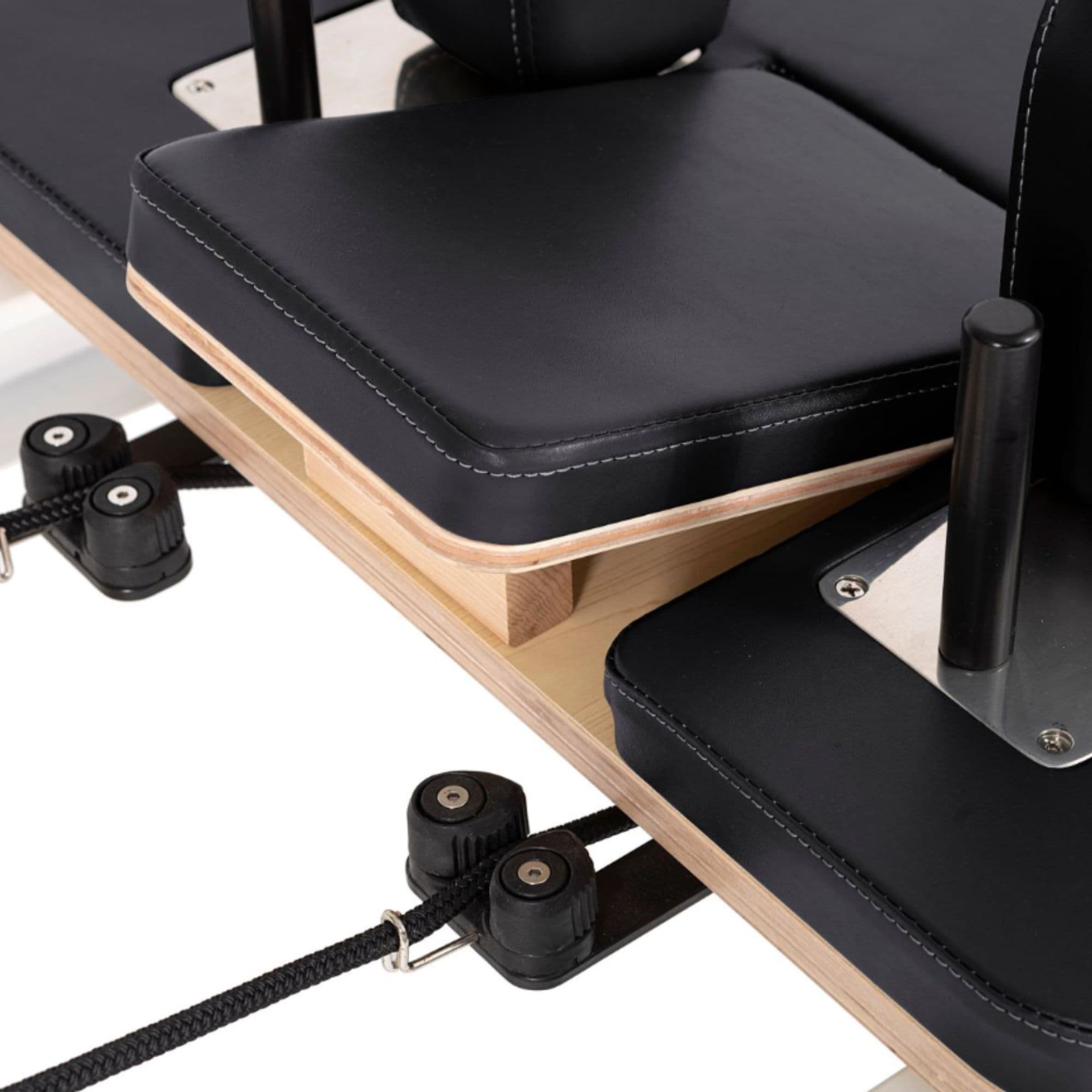Elina Nubium Reformer with Tower Bundle Close-Up View Of Black Upholstery And Shoulder Rest Assembly