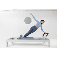 Thumbnail for Elina Pilates Classic Aluminium Reformer 86 Inches  With A Woman Performing Exercise While One Hand Raise And The Other Is Holding At The Footbar