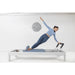 Elina Pilates Classic Aluminium Reformer 86 Inches  With A Woman Performing Exercise While One Hand Raise And The Other Is Holding At The Footbar