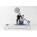 Elina Pilates Classic Aluminium Reformer 86 Inches With One Older Woman Assisting The Young Girl While Performing The Exercise