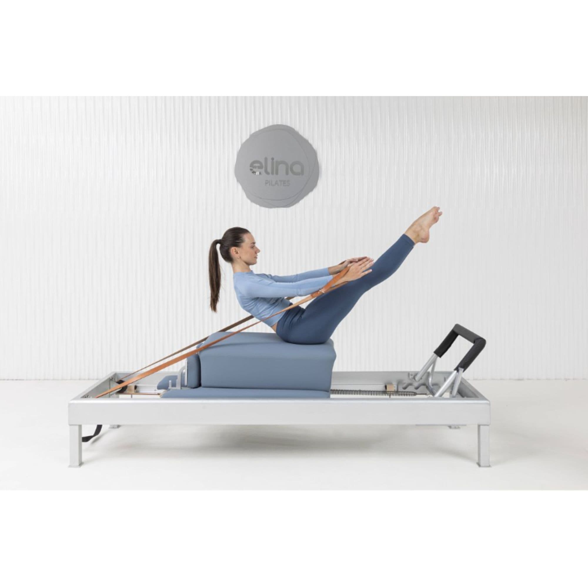Elina Pilates Classic Aluminium Reformer With A Woman Performing Exercise And A Brand Logo In The Background