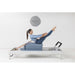 Elina Pilates Classic Aluminium Reformer With A Woman Performing Exercise And A Brand Logo In The Background
