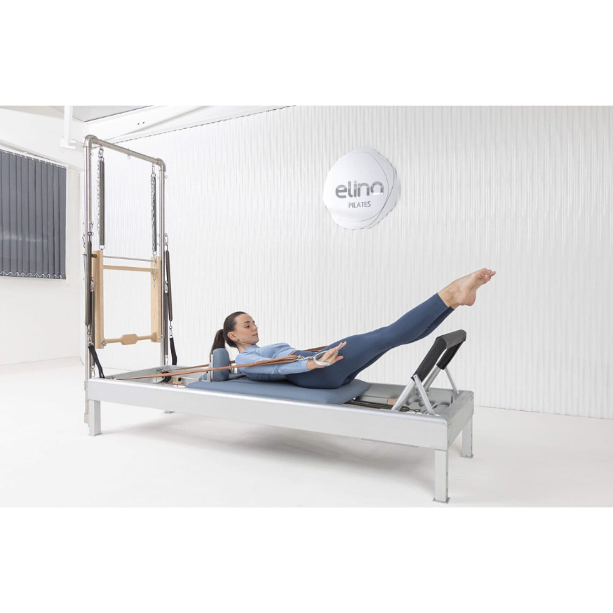 Elina Pilates Classic Aluminium Reformer with Tower 86 Inches With A Woman Performing Exercise Using The Leather Straps