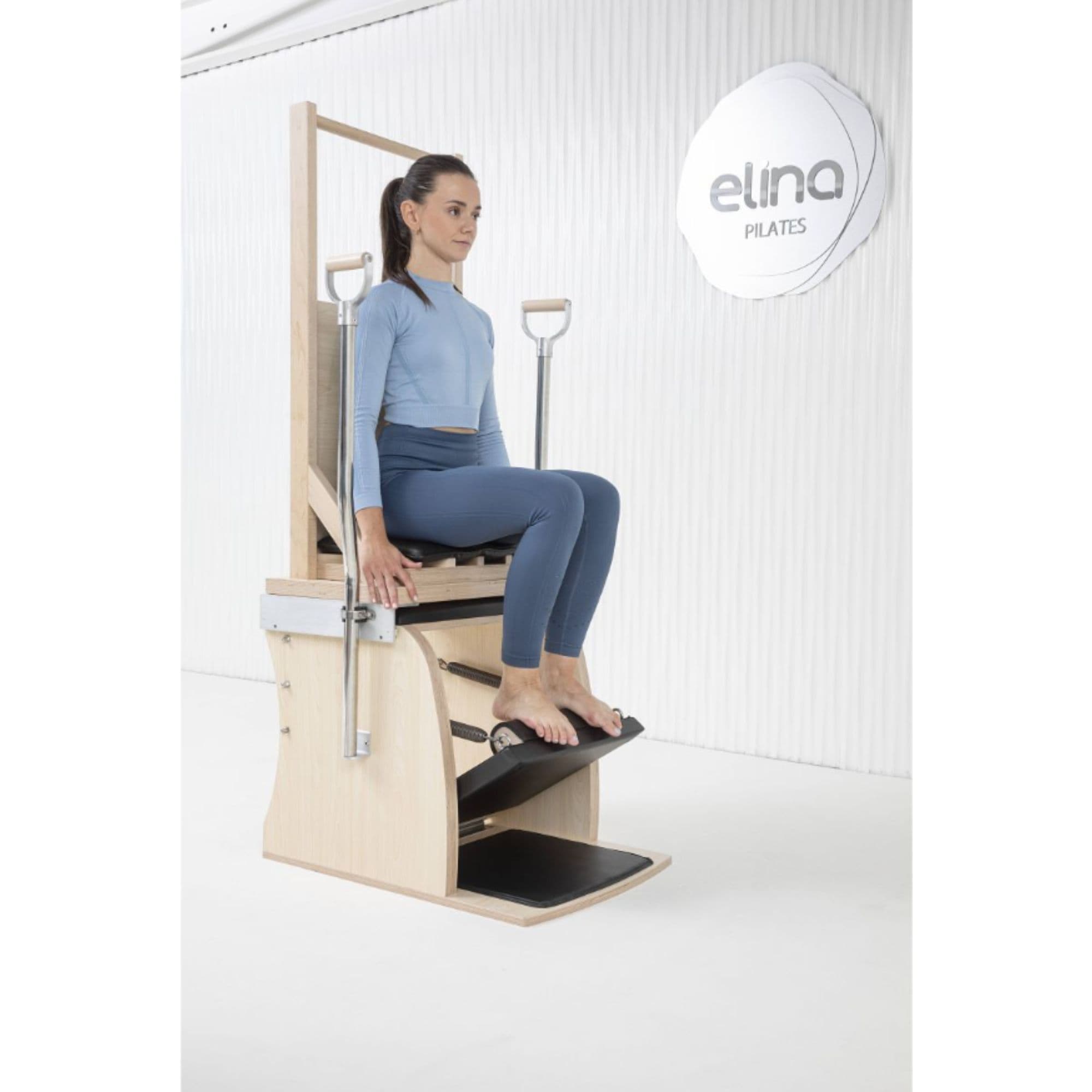 Elina Pilates Combination Wunda  Electric Chair With A Woman Preparing For A Pilates Arm Chair Exercise