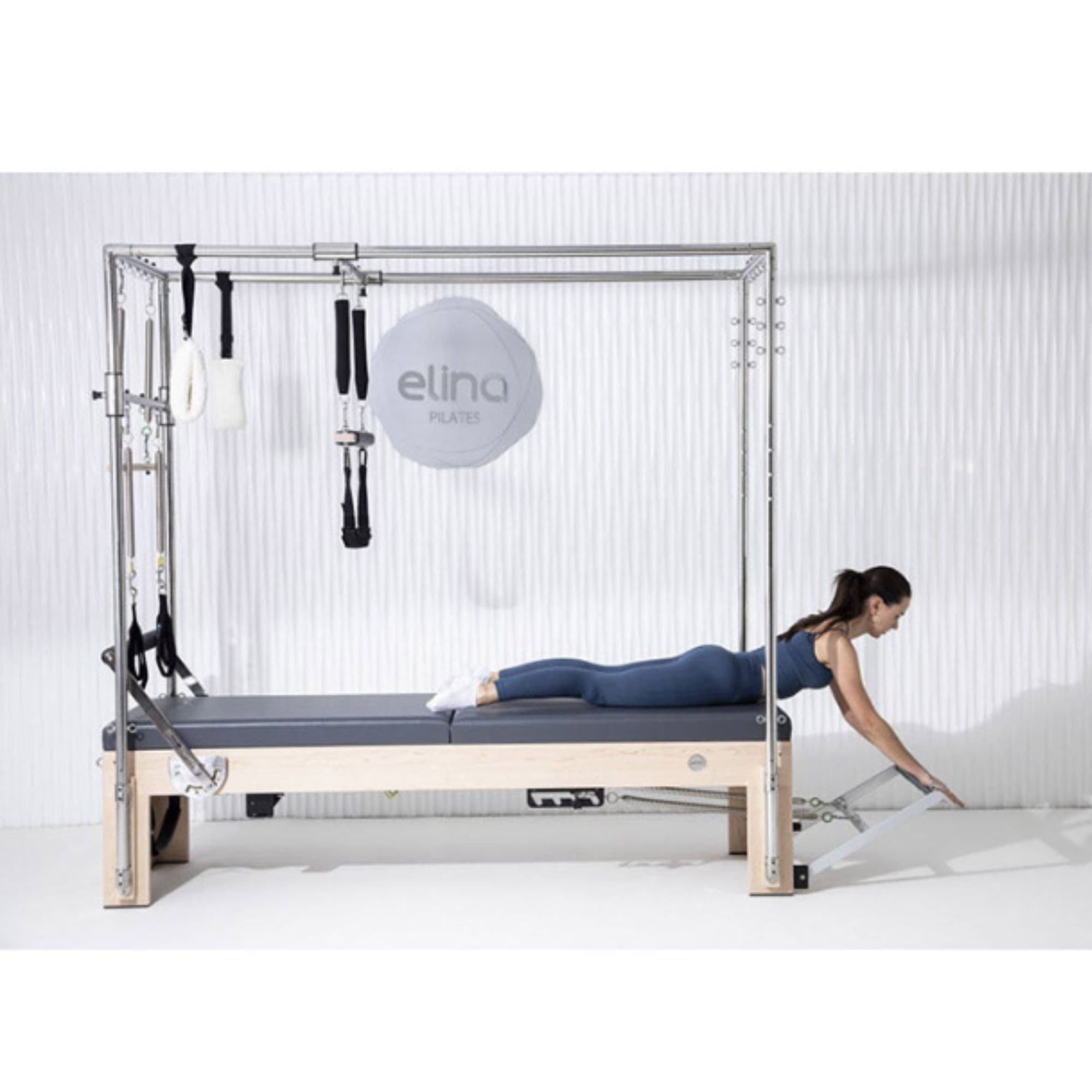 Elina Pilates Elite Cadillac Reformer Side View With A Woman Performing Cobra Pose Exercise