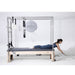 Elina Pilates Elite Cadillac Reformer Side View With A Woman Performing Cobra Pose Exercise