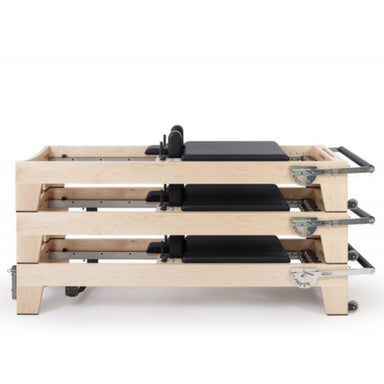 Elina Pilates Elite Wood Reformer Black Variant Side View In Stacked Storage Position On White Background