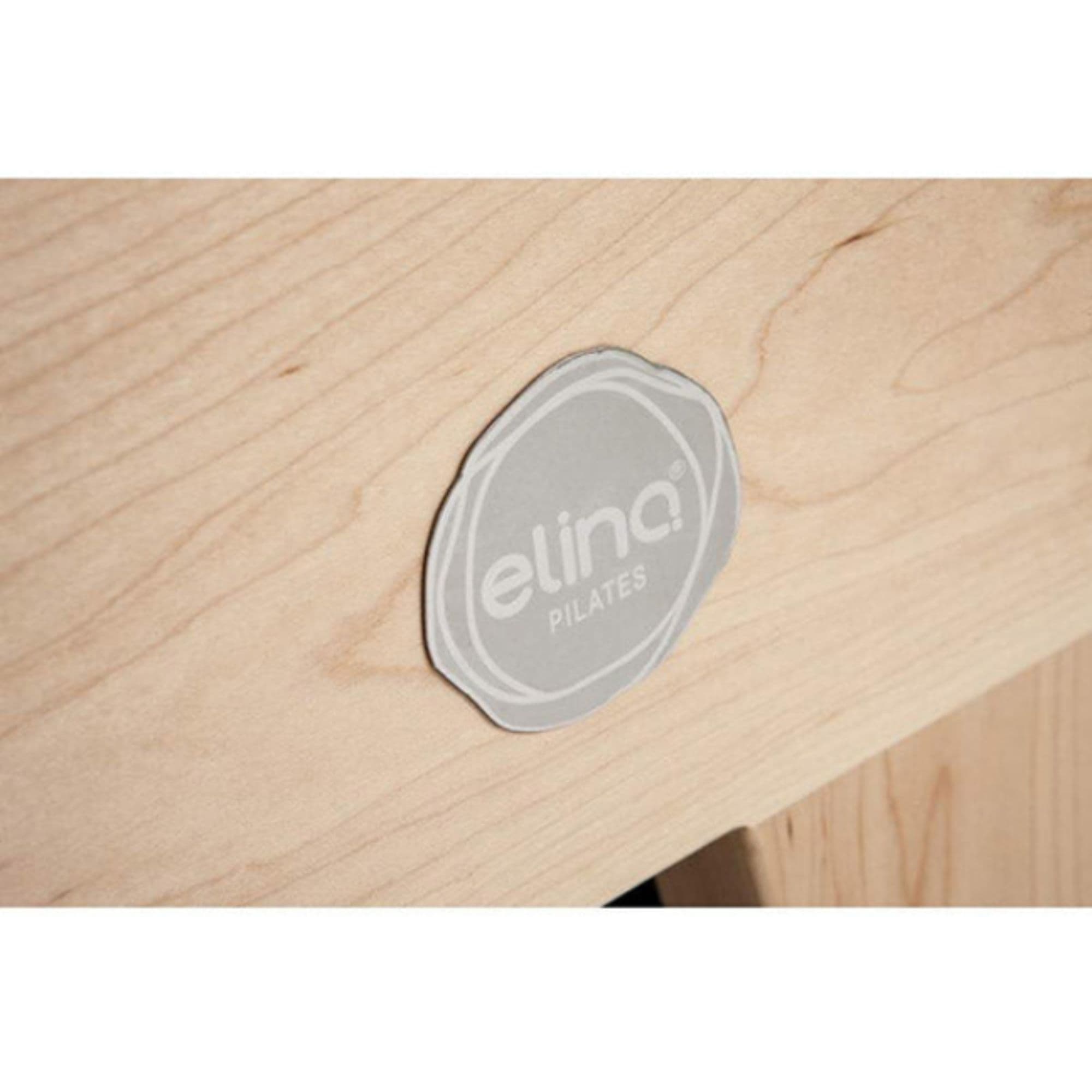 Elina Pilates Elite Wood Reformer with Tower With A Brand Logo Attached On The Wood