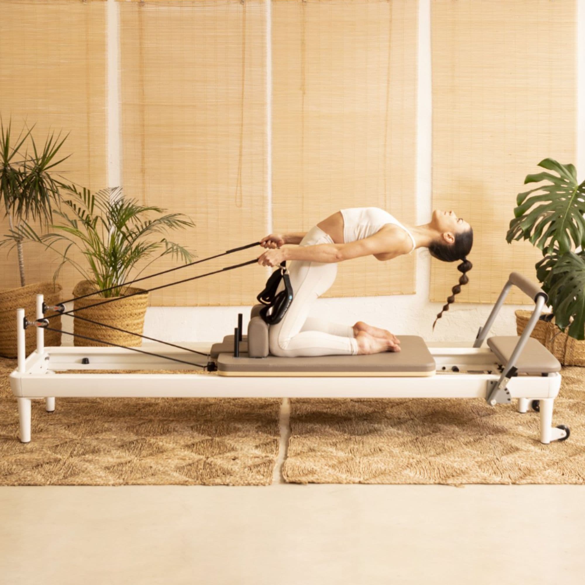 Elina Pilates Nubium Lifestyle Side View Of Woman Performing Pilates Exercise In Studio Setting