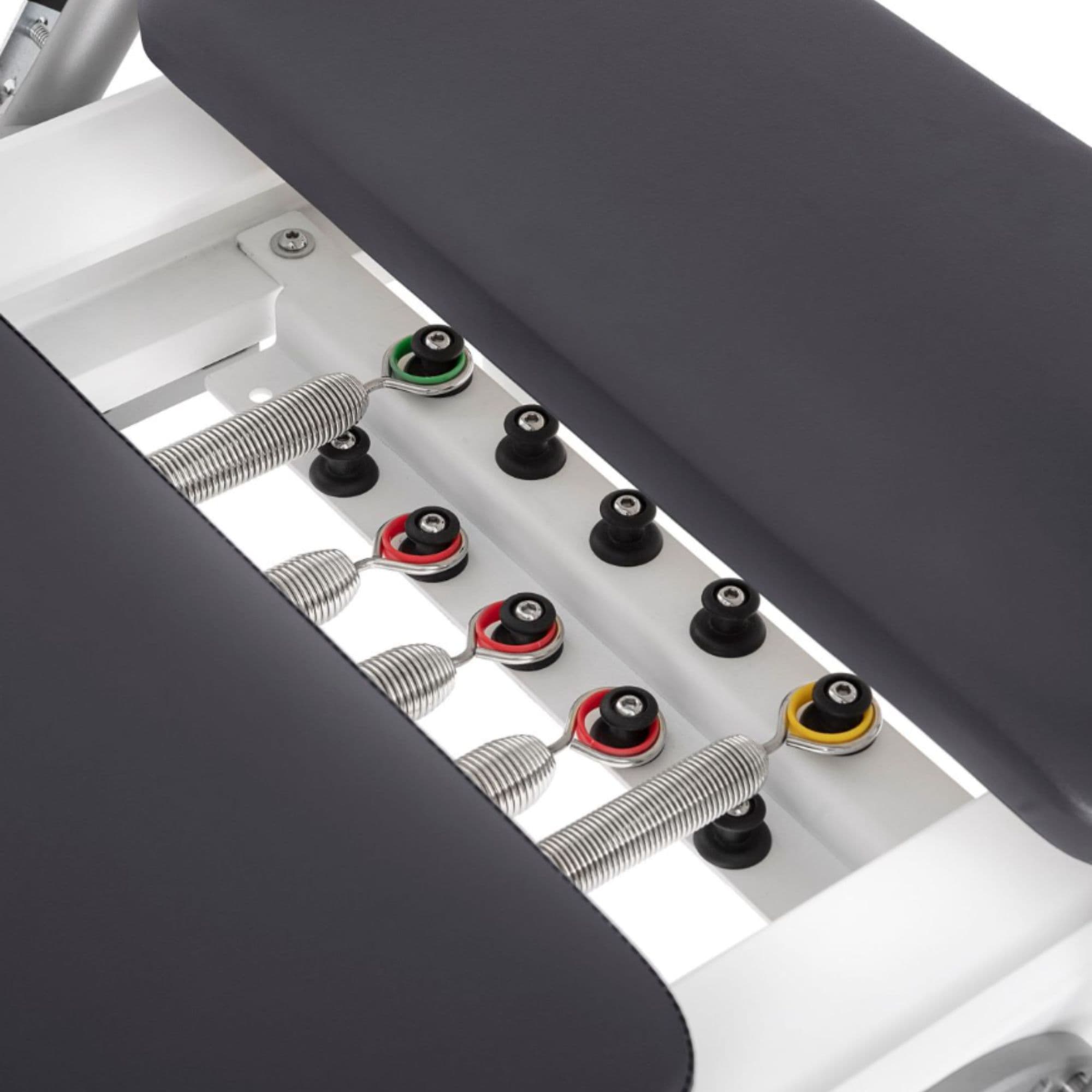 Elina Pilates Nubium Reformer And Tower Set Close-Up View Of Color-Coded Springs And Black Upholstered Cushion