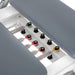 Elina Pilates Nubium Reformer Bundle Close-Up View Of Color-Coded Springs And Gray Upholstered Cushion