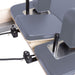 Elina Pilates Physio Reformer Master Instructor Close-Up View Of Reformer Rope Guide Pulleys On Grey Upholstered Bed