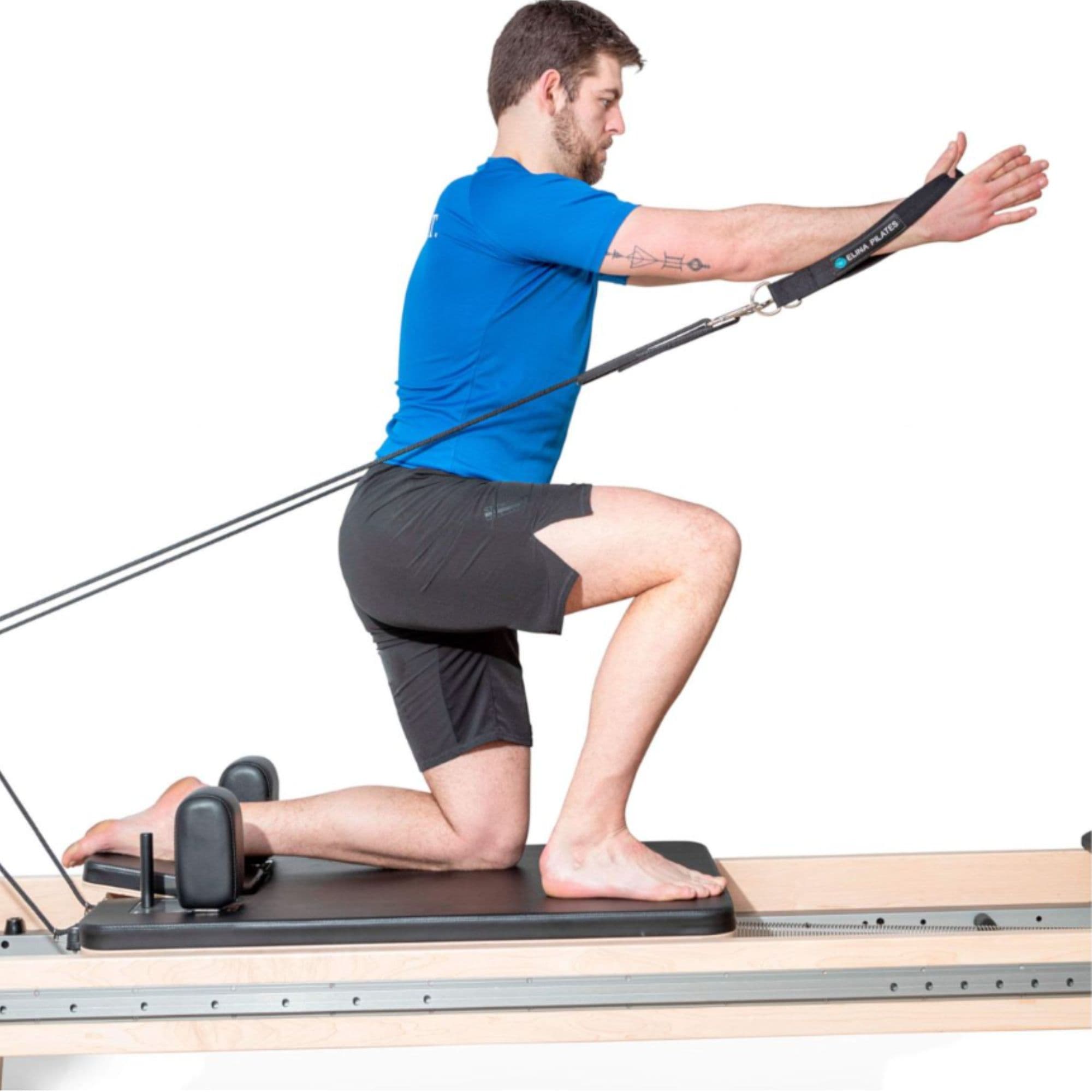 Elina Pilates Physio Reformer Master Instructor With A Man Performing A Half-Kneeling Pilates Resistance Exercise Using An Arm Strap