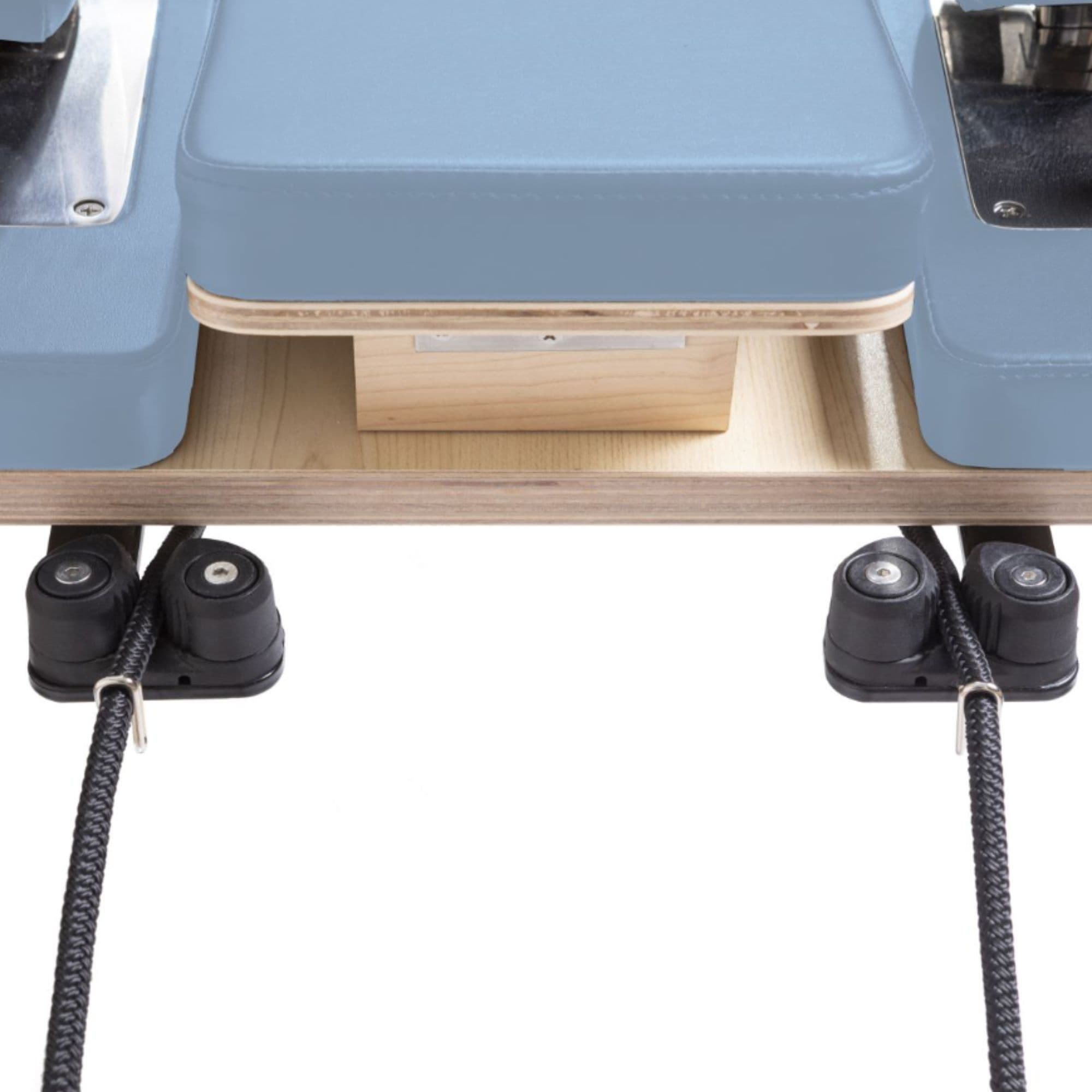 Elina Pilates Physio Reformer Master Instructor with Tower Close-Up View Of Reformer Rope Guide Pulleys On White Background