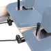 Elina Pilates Reformer Master Instructor With Tower Close-Up View Of Reformer Rope Guide Pulleys On Ocean Blue Upholstered Bed