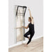 Elina Pilates Wall Board ONNE Basic Variant Lifestyle View Showing A Woman Exercising