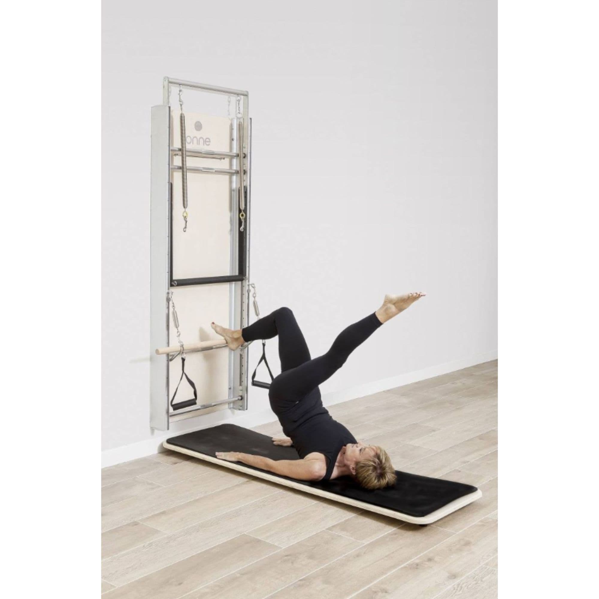 Elina Pilates Wall Board ONNE With A Woman Performing Single-Leg Bridge Exercise